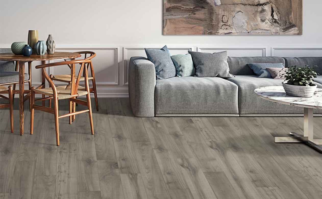 Living room with soft grey furniture and carpet.